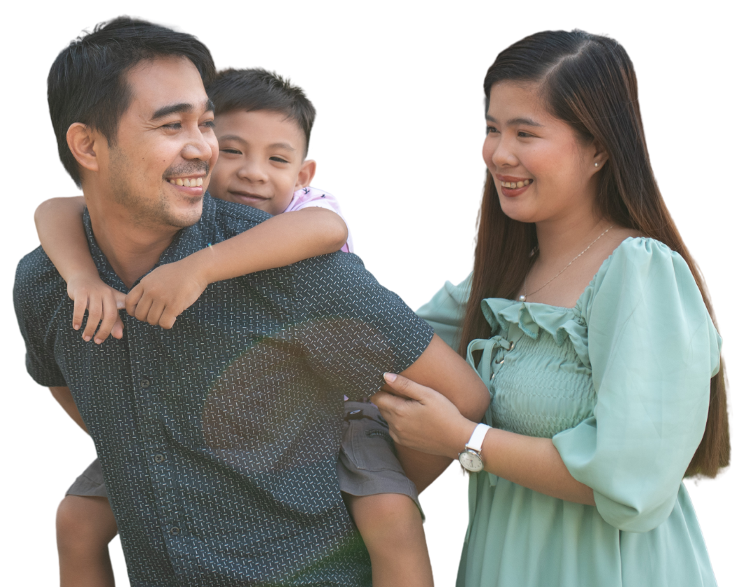 Happy Filipino family — father carrying child with mother beside them
